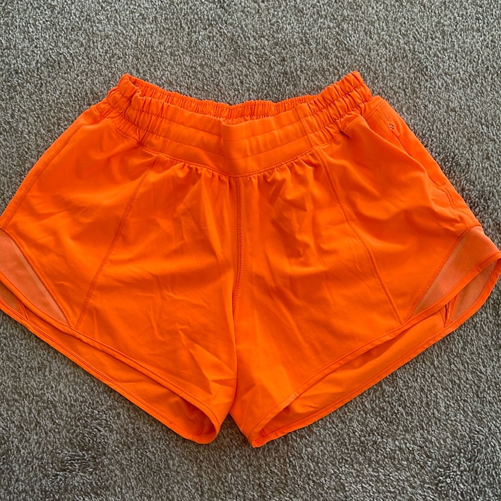 Bright orange Lululemon athletic shorts